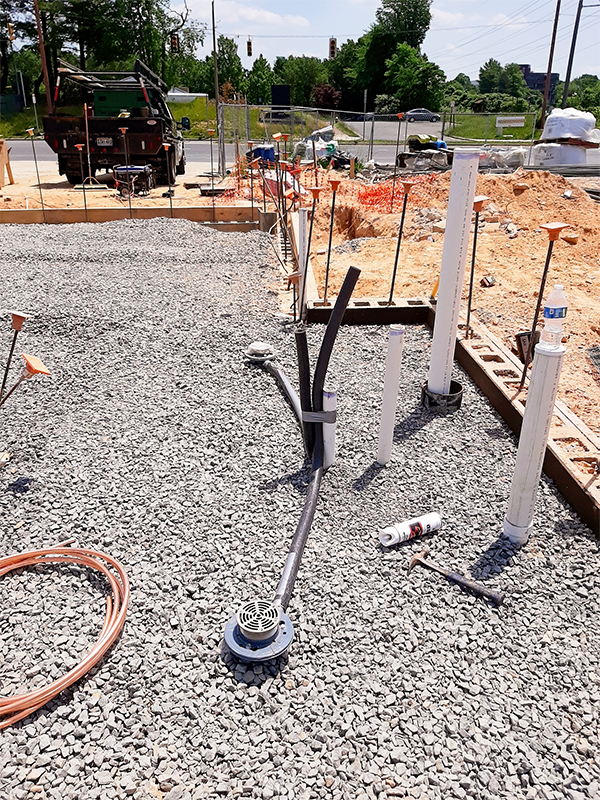 Floor drains and piping stubouts ready for concrete pour